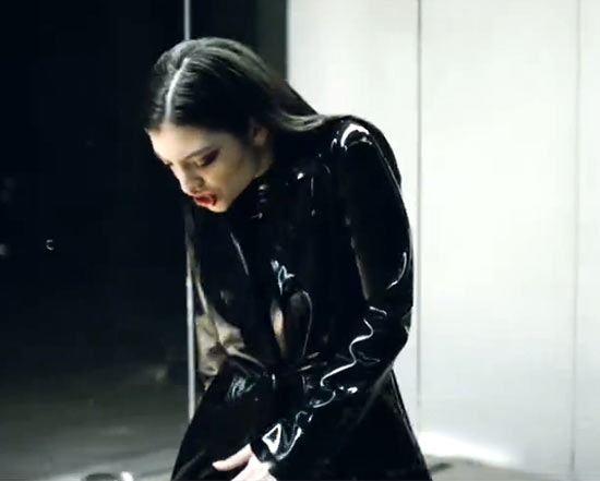 Lorde rocking a latex trenchcoat and catsuit from Syren in her latest video, "Magnets"